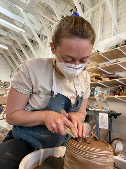 Clay artist working at potter's wheel.