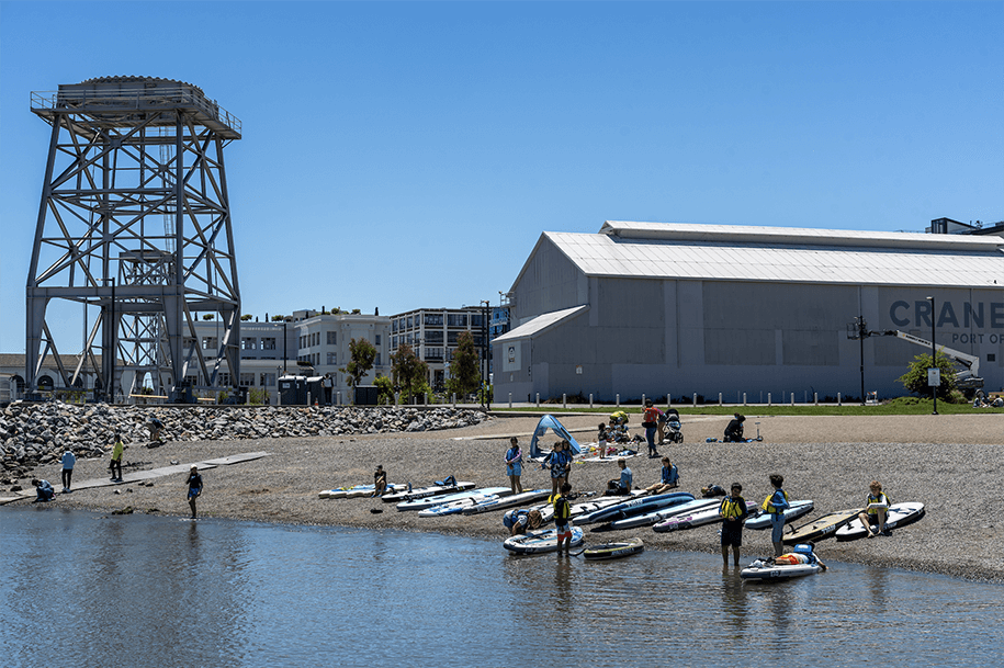 Photo: Dogpatch Paddle summer campers exit the water at Crane Cove Park. The park was completed in 2020 on the historic shipbuilding site of Union Iron Works and Bethlehem Shipbuilding Corporation.