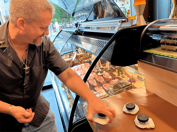 Guy Crims prepares jars of caviar for the counter case at Niku Butcher Shop. Photo: Mark Steensland